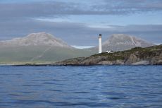 Looking east from the sea to Ruvaal Lighthouse, with the Paps of Jura in the background. Photograph: Andrea Jones/Country Life Picture Library