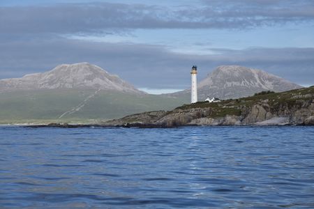 Looking east from the sea to Ruvaal Lighthouse, with the Paps of Jura in the background. Photograph: Andrea Jones/Country Life Picture Library