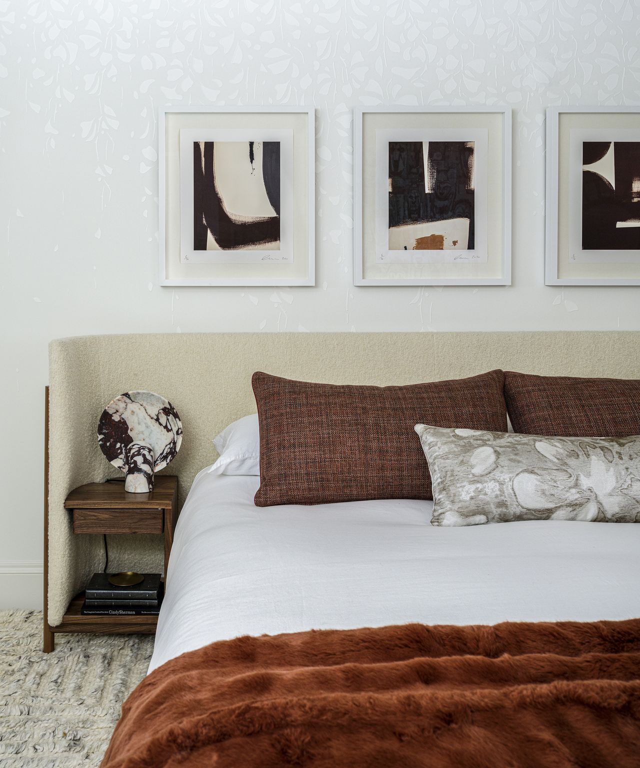 triptych of art above a large bed