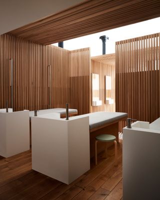 Alternative view of the wooden hair washing area at Spiral (x,y,z) featuring hair-washing beds and white hair washing units
