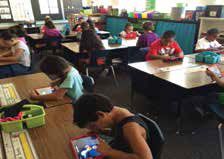Students at Bean Elementary engage in learning on their devices.