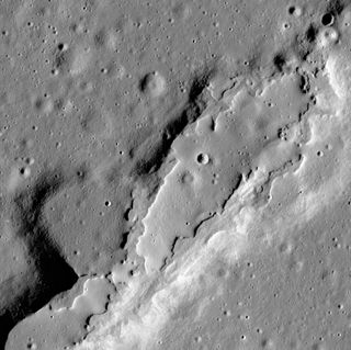 This photo from the Lunar Reconnaissance Orbiter Camera shows lava flows that spread across the floor of a large, collapsed area. The flows have few impact craters and steep sides, suggesting the eruptions were recent.