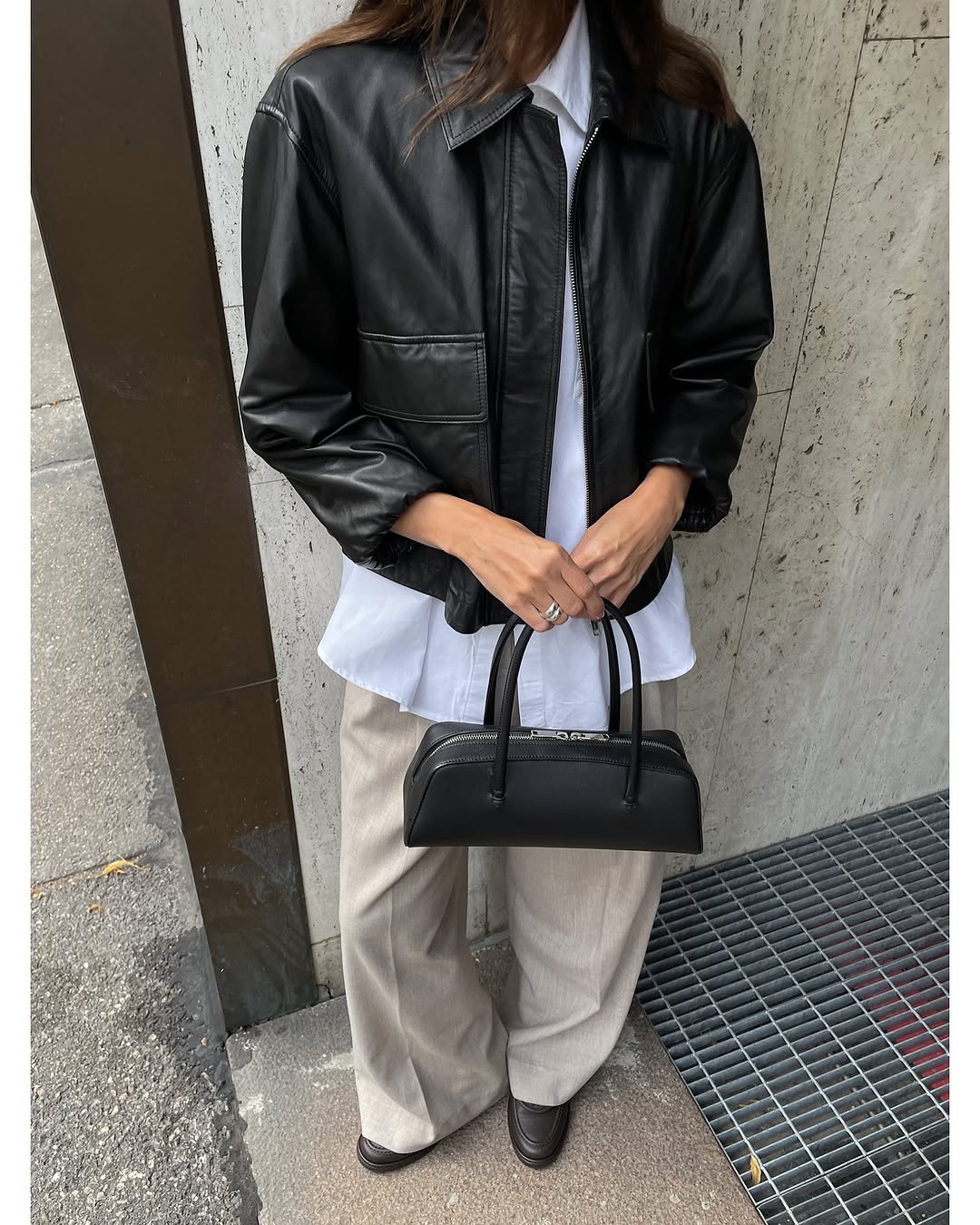 Woman wearing collared leather jacket trend fall 2025.