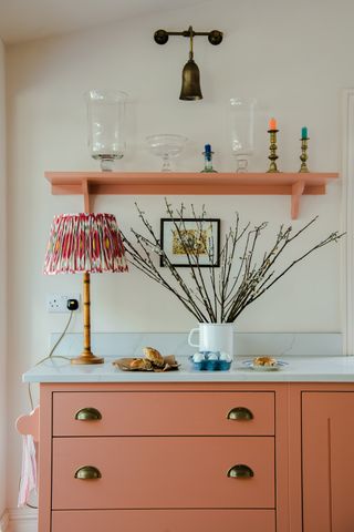 British Standard by Plain English cupboards with coral cabinets and open shelf