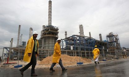 Workers walk through the South Pars gas filed in Assalouyeh, Iran, Jan. 27, 2011.