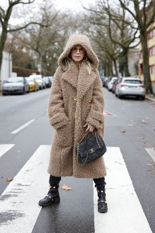 woman wearing hooded teddy coat and boots