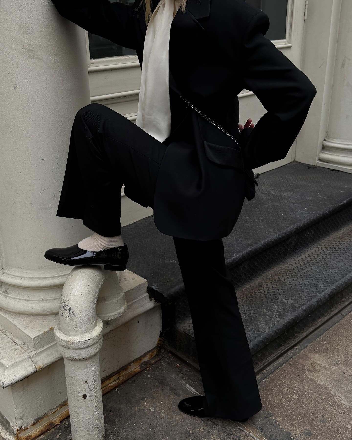 @christietyler wears a black blazer and black trousers with Chanel Resort 2025 patent leather moccasins.