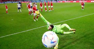 England&#039;s Marcus Rashford scores their first goal from a free kick past Wales&#039; Danny Ward during the FIFA World Cup Qatar 2022 Group B match between Wales and England at Al Janoub Stadium on November 29, 2022 in Doha, Qatar.