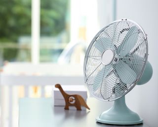 a retro blue fan in a nursery room