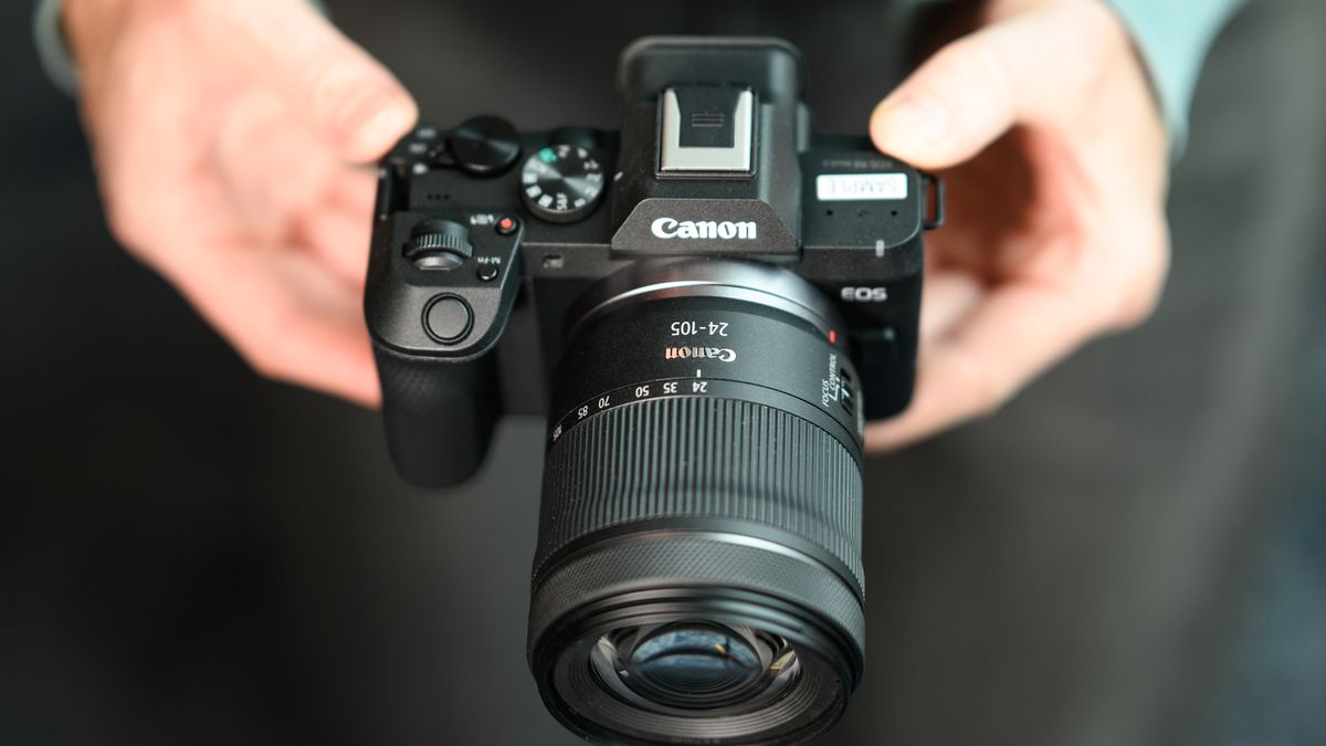 Top of the Canon EOS R8 Mark II, in user's hands, 24-105mm lens attached