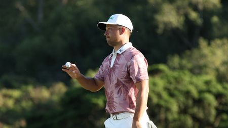 Xander Schauffele holds his golf ball up to the crowd during round two of The Sentry in 2025