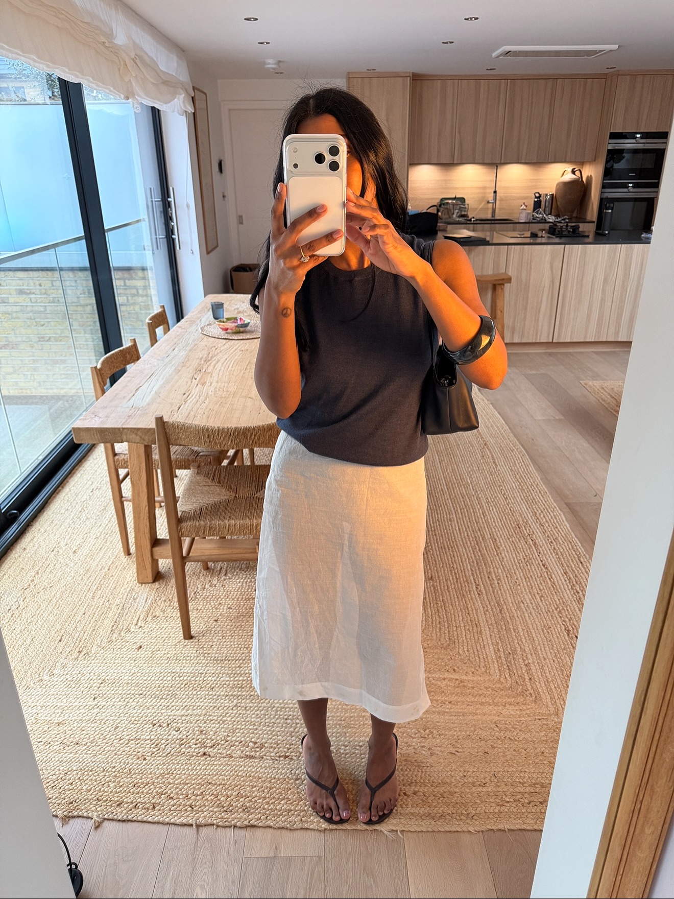 An image of a woman wearing summer knee length skirt outfit 2026