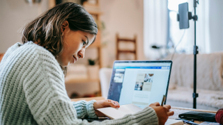 Woman sitting at laptop