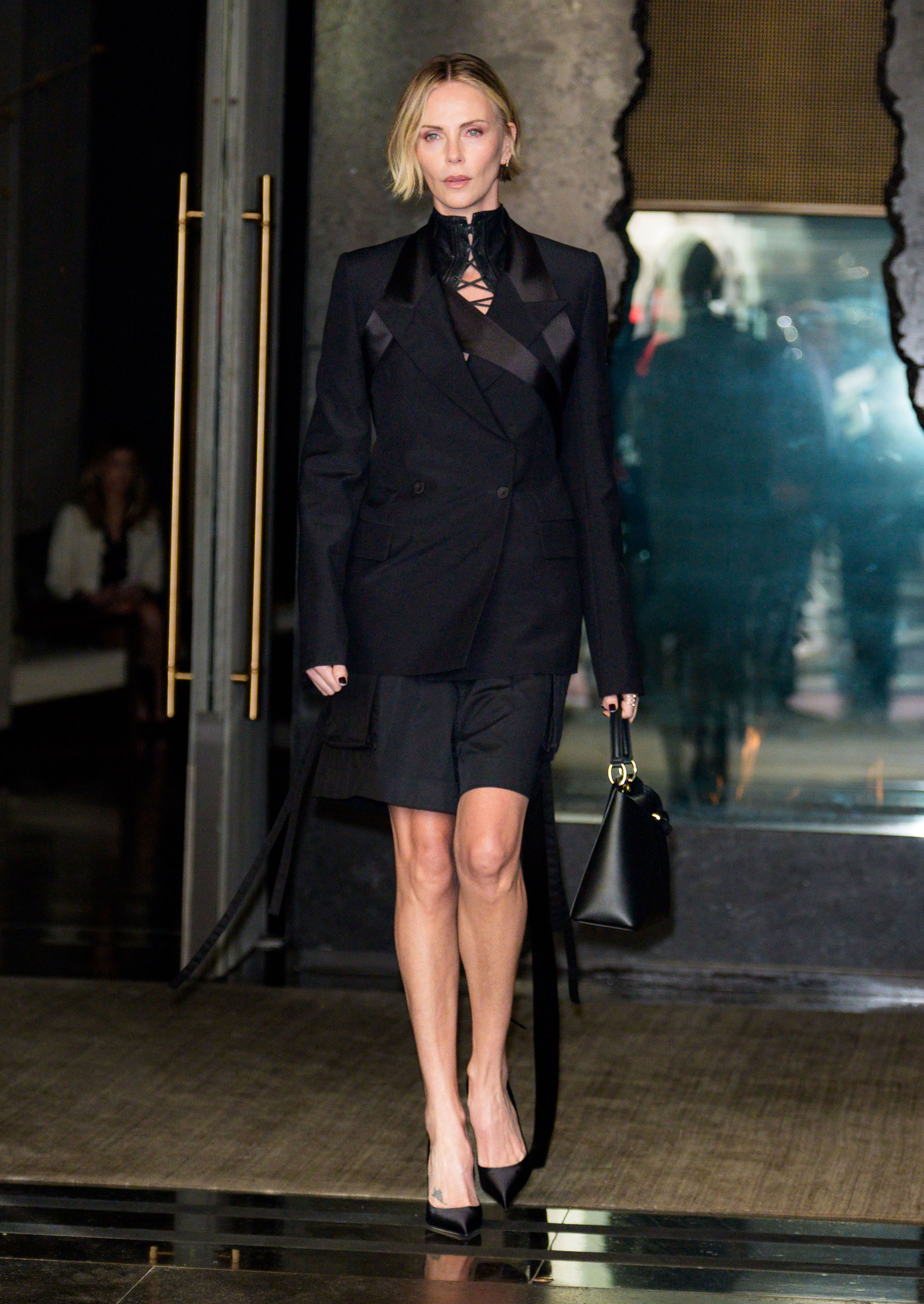 charlize theron on the apex press tour wearing black and white outfits