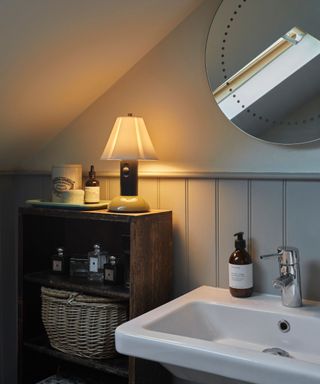 Bathroom countertop decorated with a lamp and scented candles