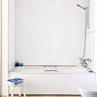 bathroom with bathtub and white walls