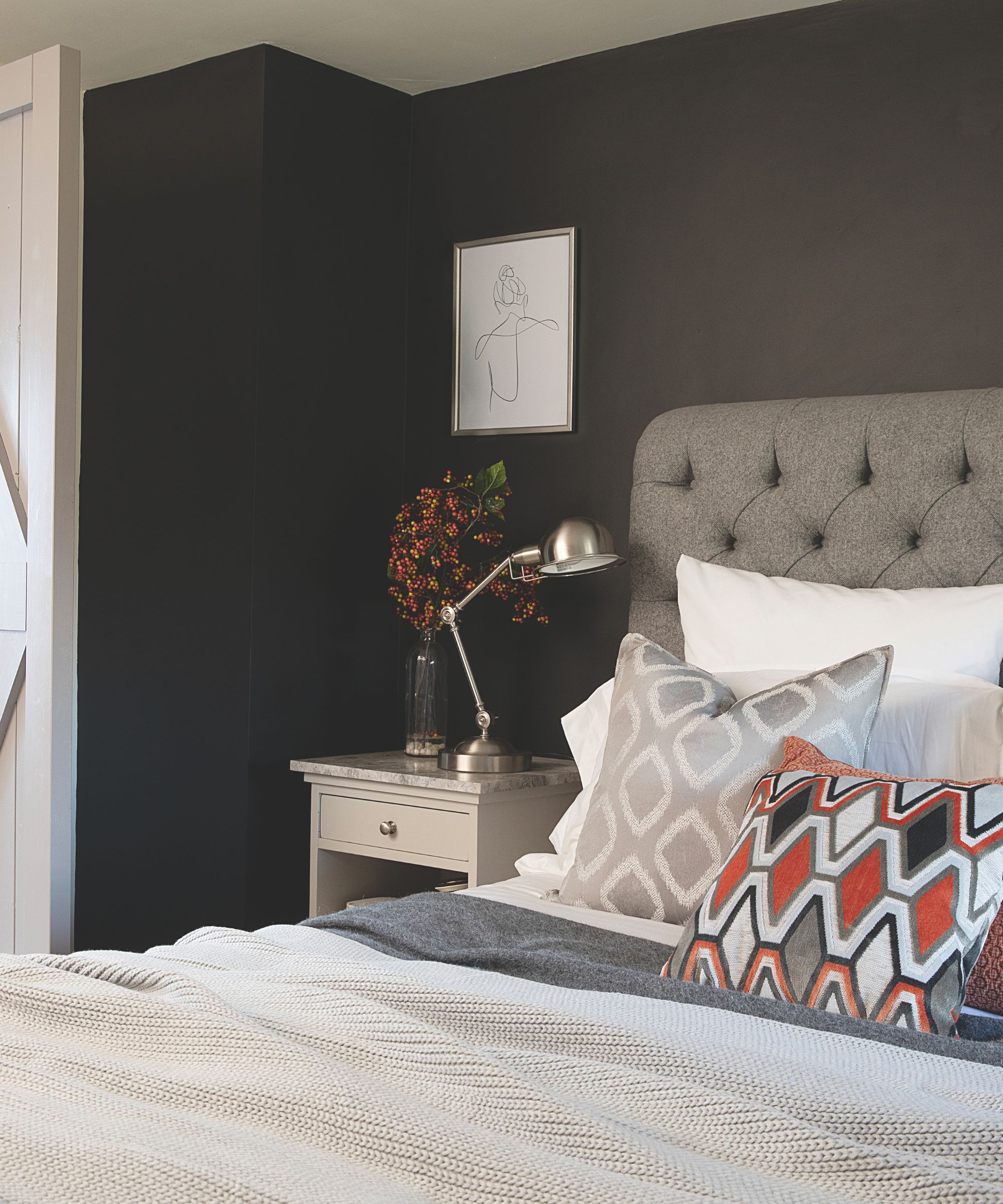 small brown bedroom with upholstered bed