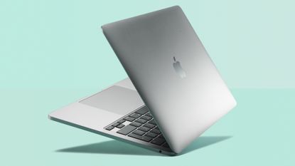 MacBook Pro in silver on green background