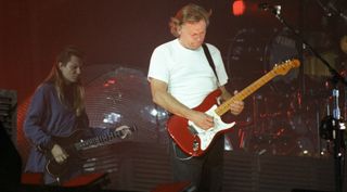 Scott Page (left) and David Gilmour of Pink Floyd perform on stage at Wembley Stadium on the 'A Momentary Lapse of Reason' tour, on August 5, 1988 in London