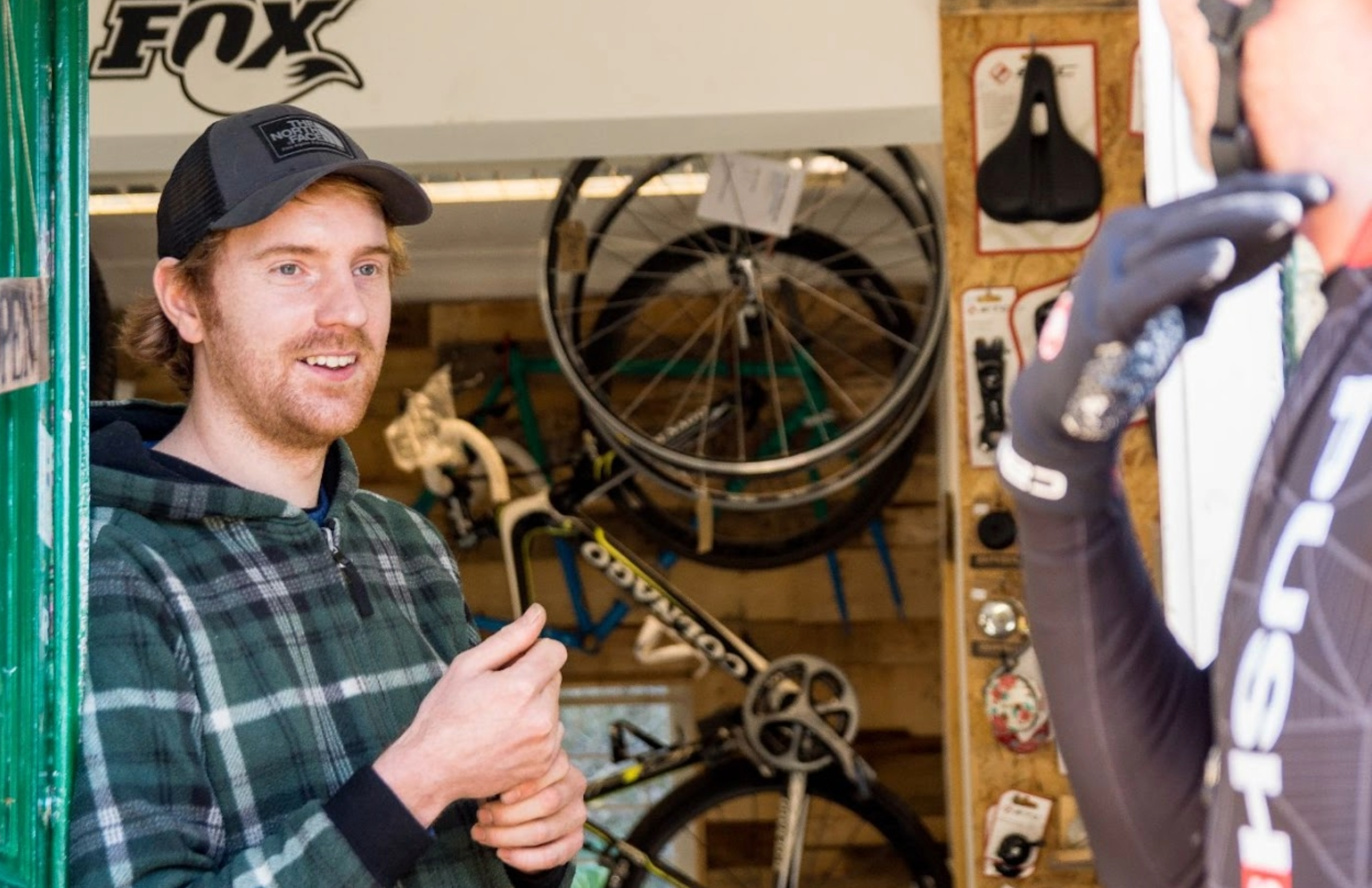 Man stands in entrance to bike workshop
