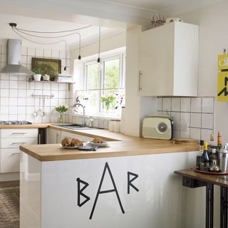 kitchen with white tiled walls and wooden countertops