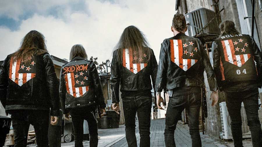 Skid Row with their backs to the camera