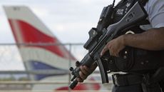An armed officer patrols Heathrow Airport