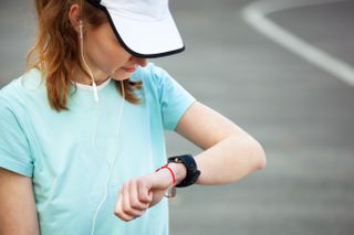 a woman checking her running watch