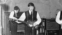 Rock and roll band "The Beatles" perform onstage at the Cavern Club on August 22, 1962.(L-R) George Harrison, Paul McCartney, John Lennon