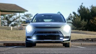 2024 Kia Niro PHEV SX Touring headlights turned on.