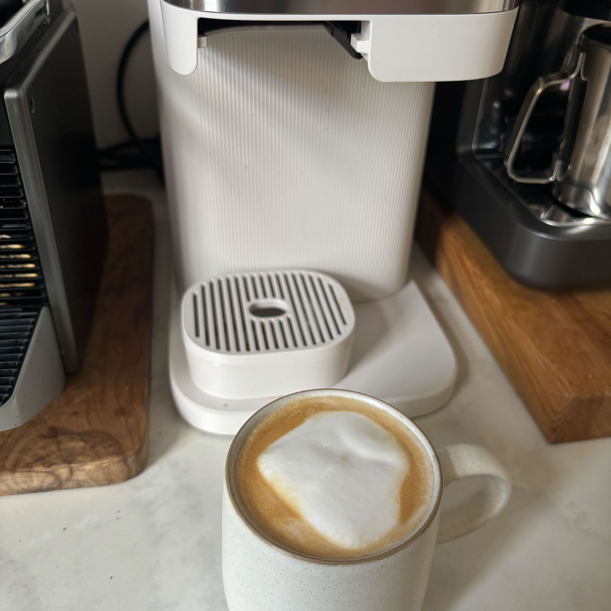 White Philips Baristina with a latte in a white mug in front