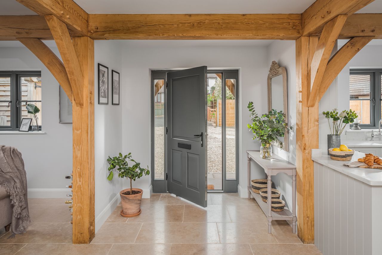 grey front door in oak frame hallway