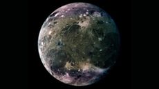 A close up of the blue and gray moon Ganymede in the darkness of space.