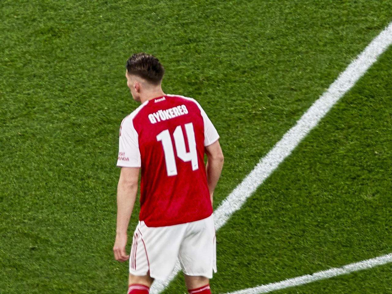 A Champions League soccer match between Arsenal and Atletico Madrid, as seen from the upper stand at the Emirates stadium, London. Zoomed in photos of the players