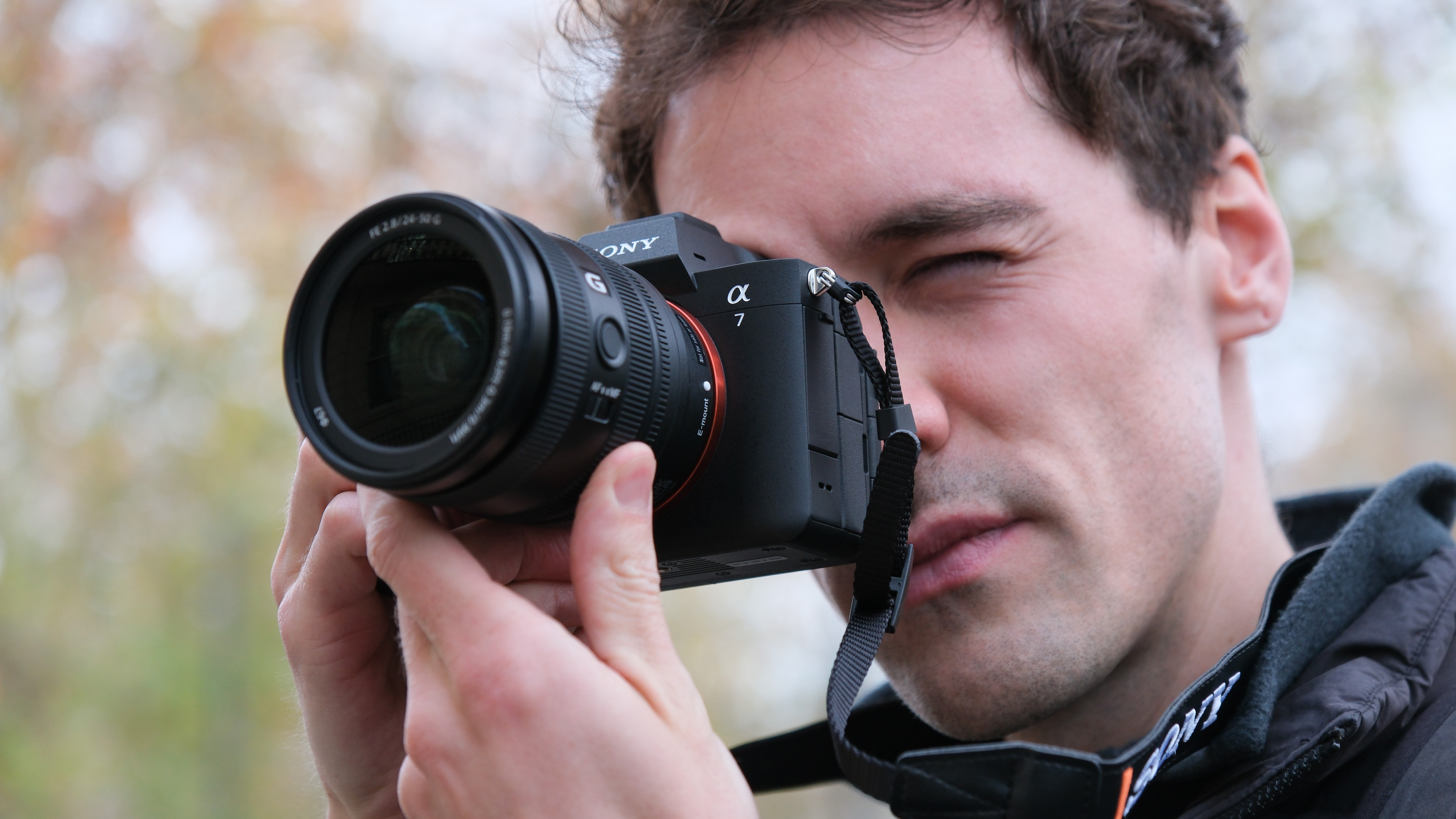 Sony A7 V camera held up to a person's face