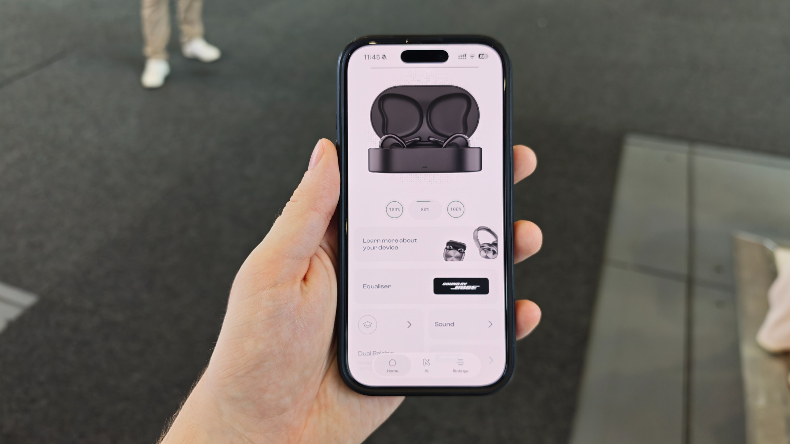 Man holding up phone with the Noise app open