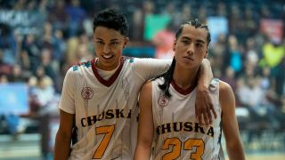 Two basketball players waling towards the camera in Rez Ball