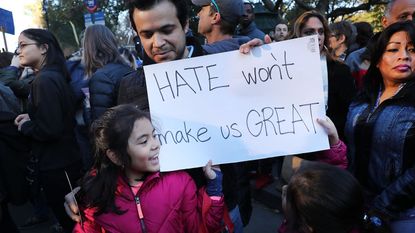 Man and girl protesting and holding banner