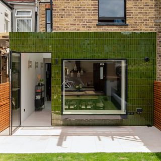 Extension with picture window and green tile cladding
