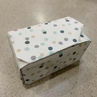 Image of wrapped present in neutral tone polka dot wrapping paper