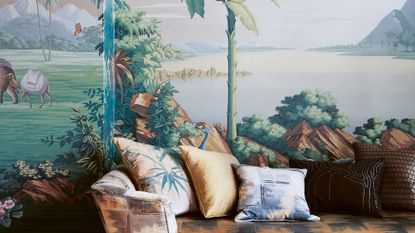 Tropical wall mural behind a colorful sofa with pillows