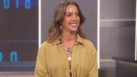 Dee Valladares on the Big Brother stage in a yellow top. 