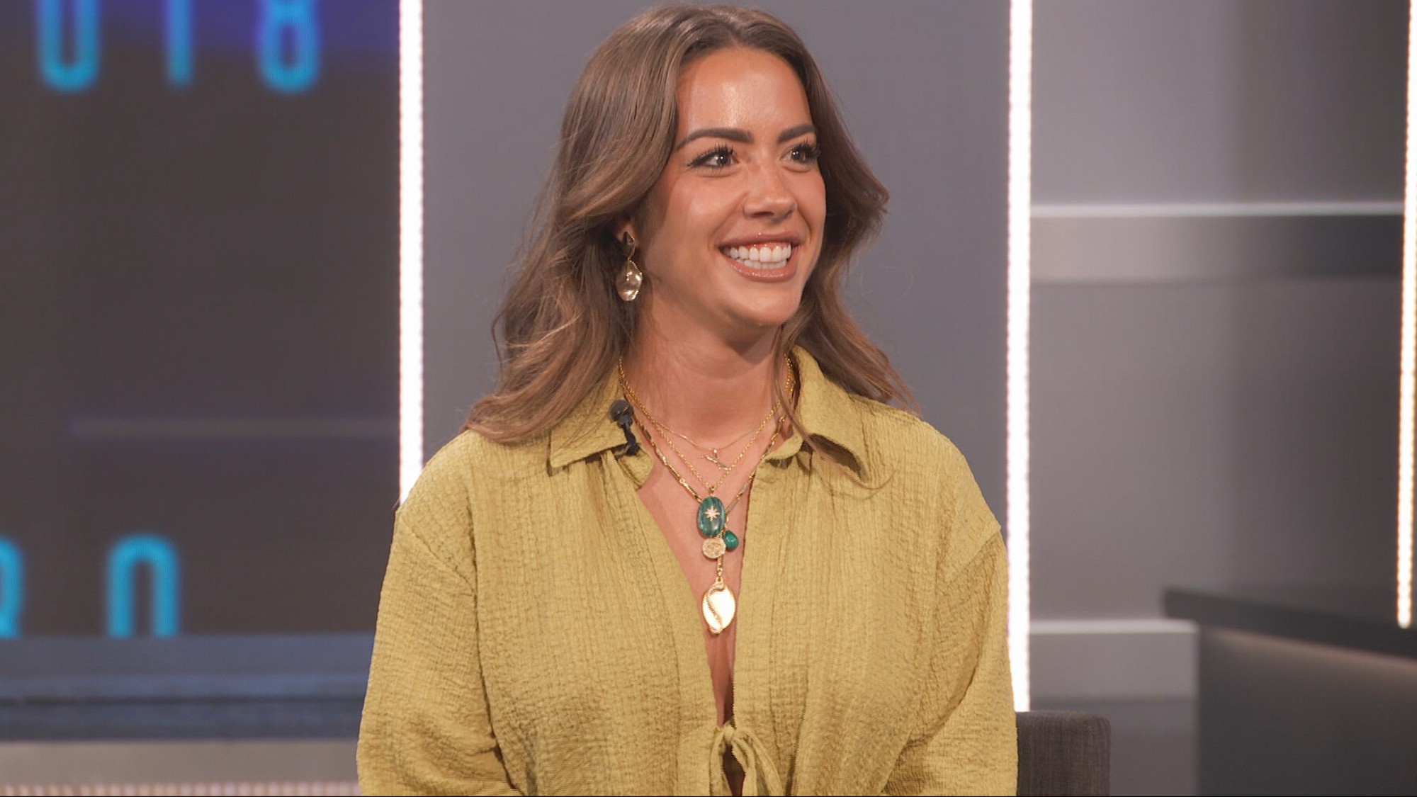 Dee Valladares on the Big Brother stage in a yellow top. 