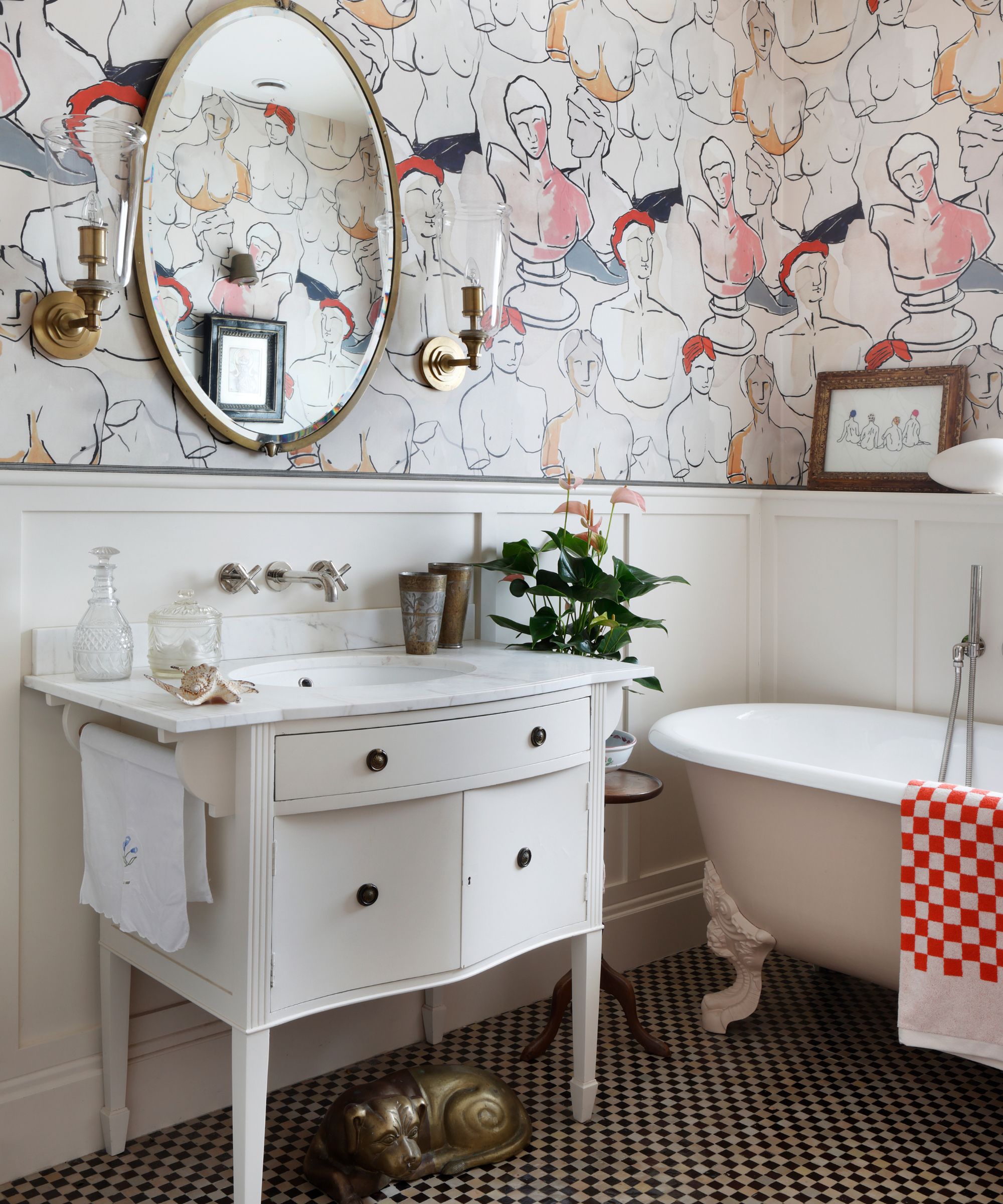 Bathroom with vintage wallpaper, freestanding vintage vanity unit, marble sink, freestanding tub and checkerboard floor