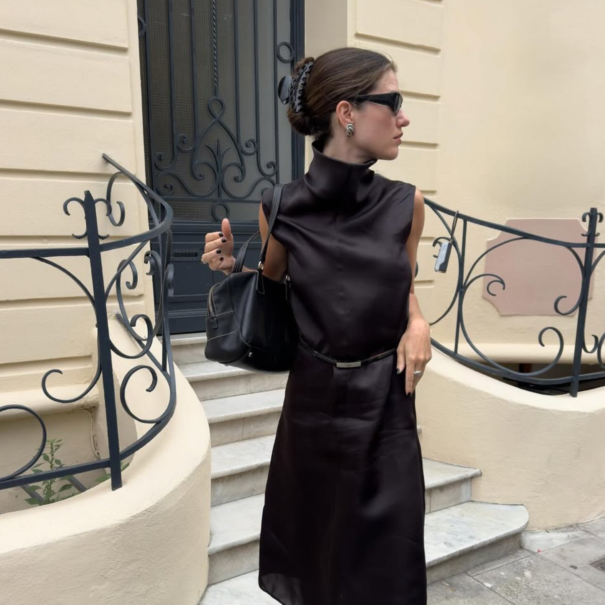 Ilirida in black dress, bag and claw clip