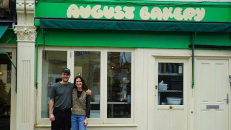an image of husband and wife duo behind the august bakery standing outside their Battersea bakery