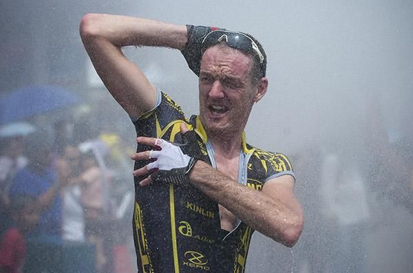 Singing in the shower: Irishman David McCann (RTS Racing Team) took the opportunity to shower when the local firemen sprayed the riders after another hot day in the saddle.