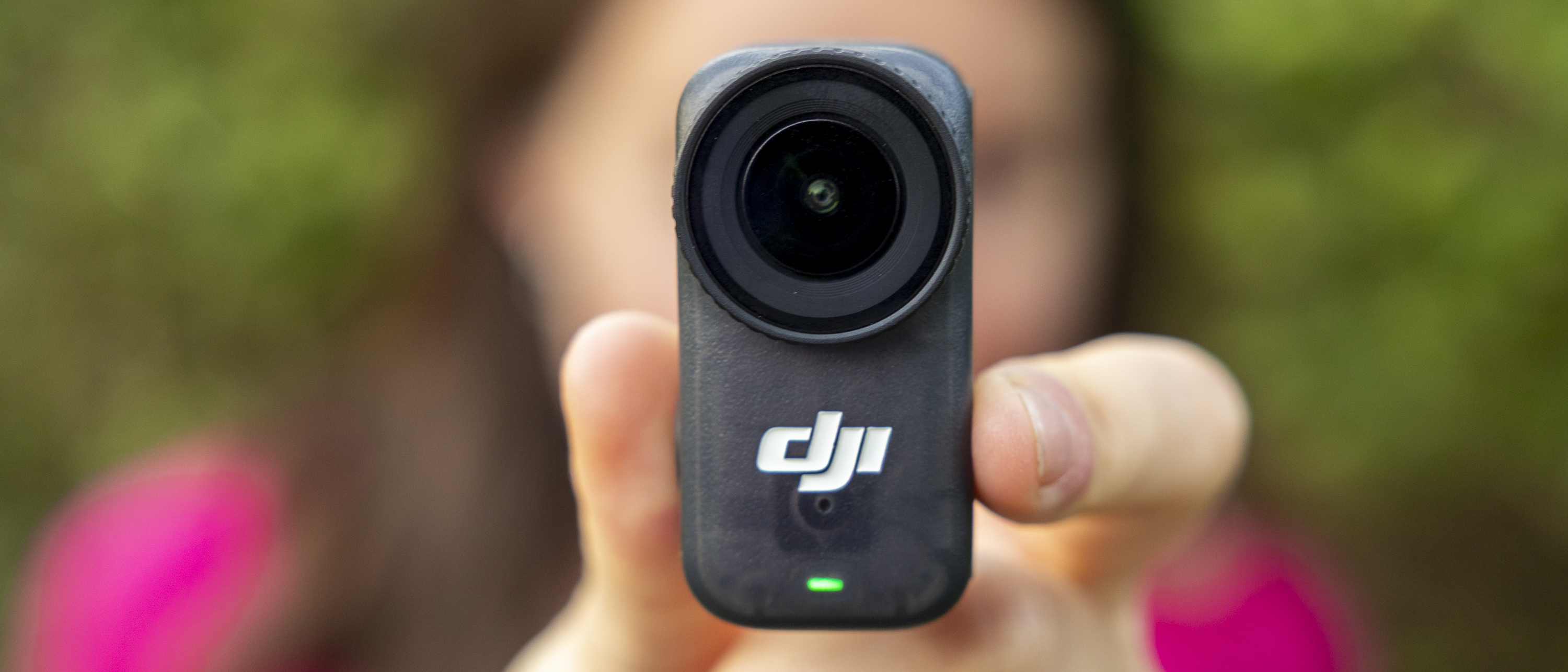 A female photographer holding the DJI osmo Nano
