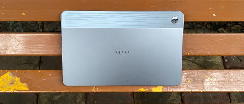 Oppo Pad Air budget tablet PC in Grey colour variant on a bench. The image shows the back of the device with the Oppo branding in the centre and the camera at the top-right corner.