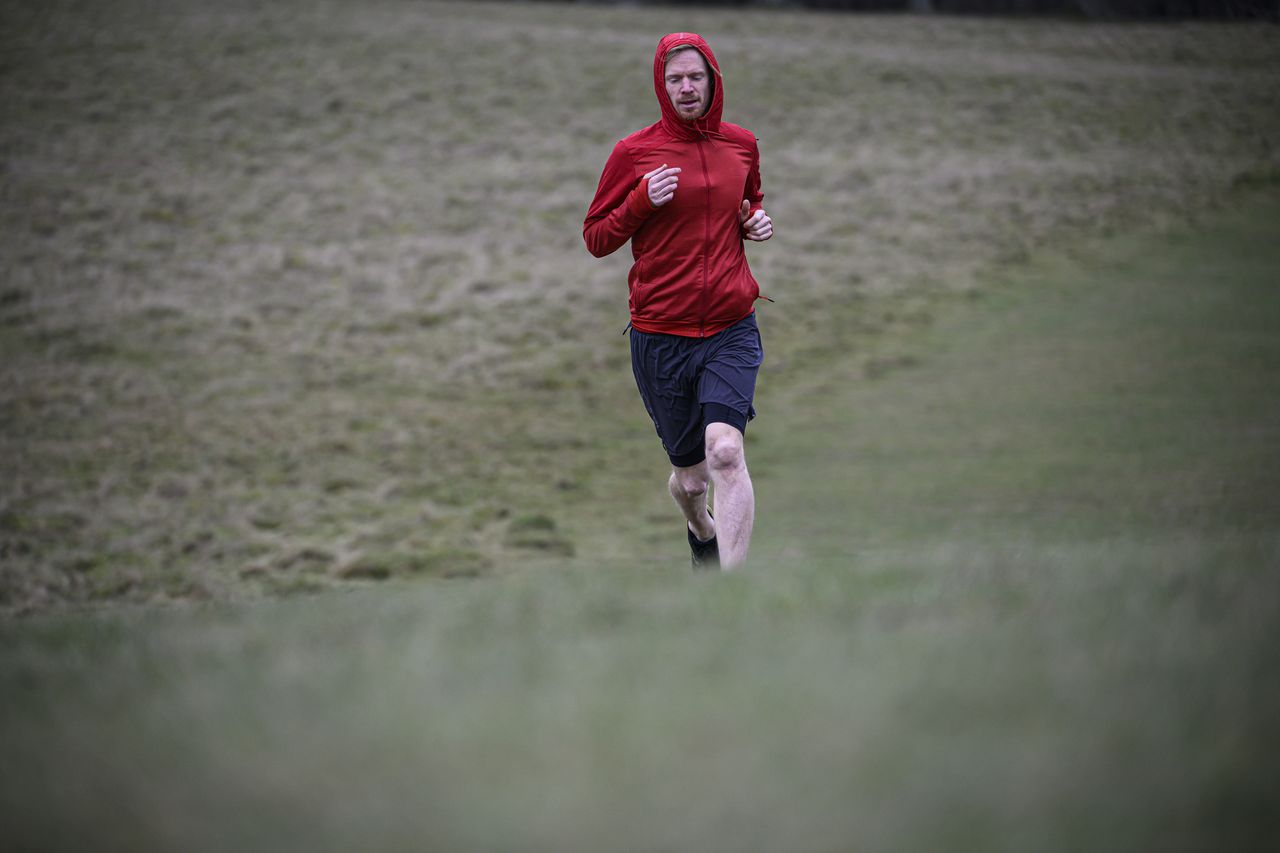 A man in a red jacket running